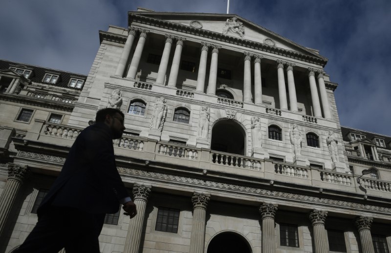 © Reuters. A man walks past the Bank of England in the City of London