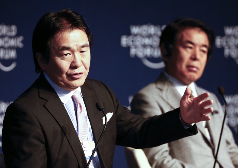 © Reuters. Takenaka, Director of Global Security Research Institute, speaks next to Shimomura, Minister of Education, Culture, Sports, Science and Technology during The New Context for Japan event in the Swiss mountain resort of Davos