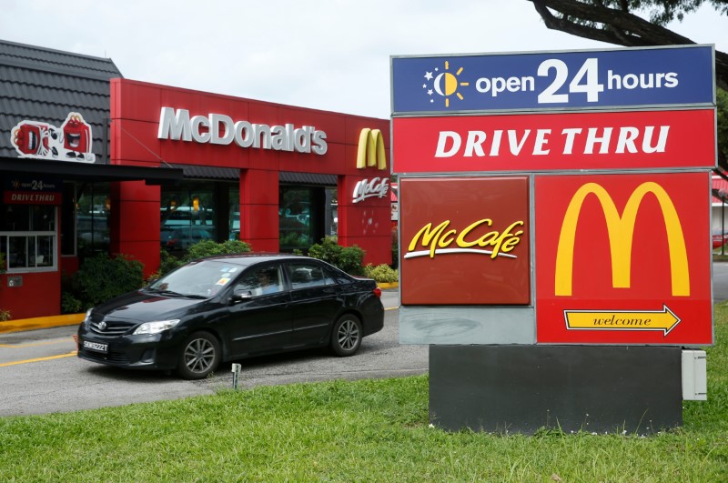 © Reuters. A car passes a McDonald's drive through restaurant in Singapore
