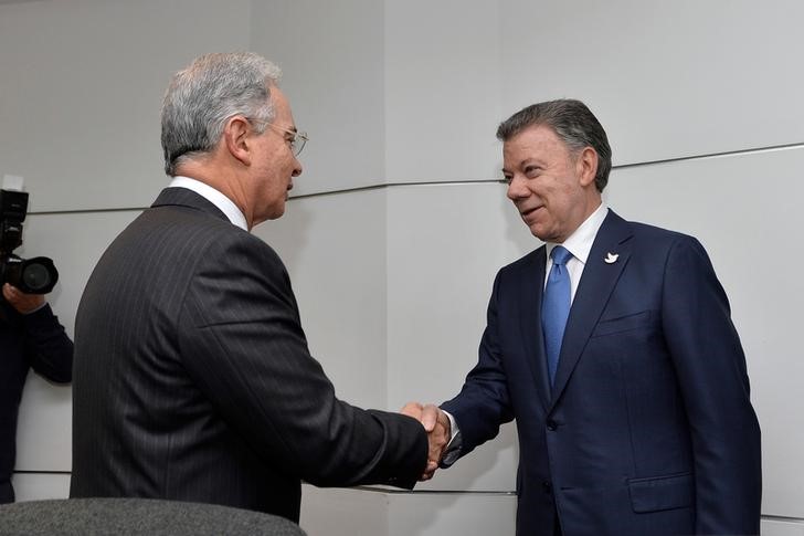 © Reuters. Uribe cumprimenta presidente Juan Manuel Santos em Bogotá