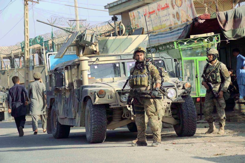 © Reuters. Afghan security forces keep watch in front of their armoured vehicle in Kunduz city