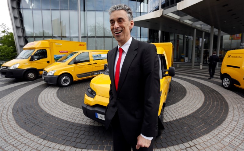 © Reuters. DHL CEO Appel poses in front of a StreetScooter E-car in Bonn