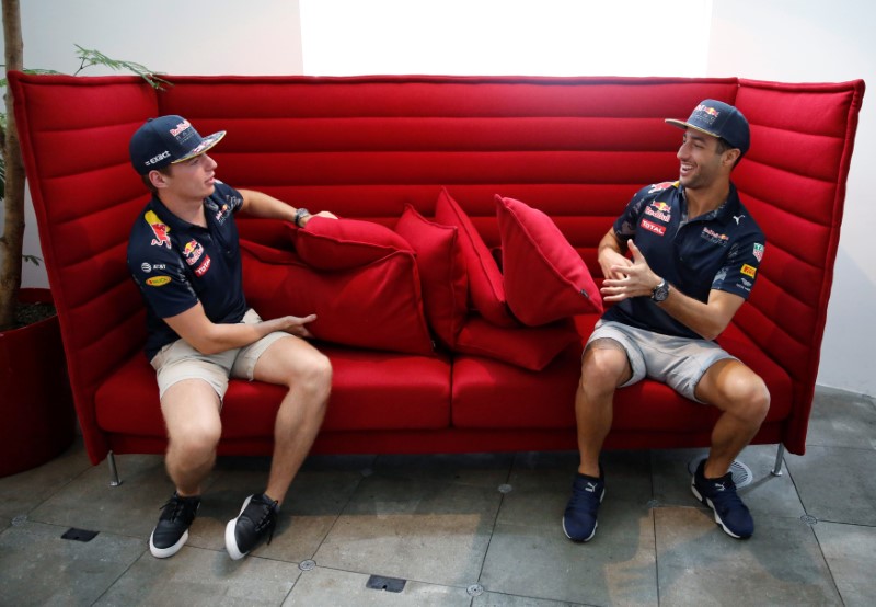 © Reuters. Red Bull Formula One driver Ricciardo of Australia and Verstappen of the Netherlands get in a 1979 Nissan Skyline in Tokyo, Japan ahead of weekend's Japanese F1 Grand Prix