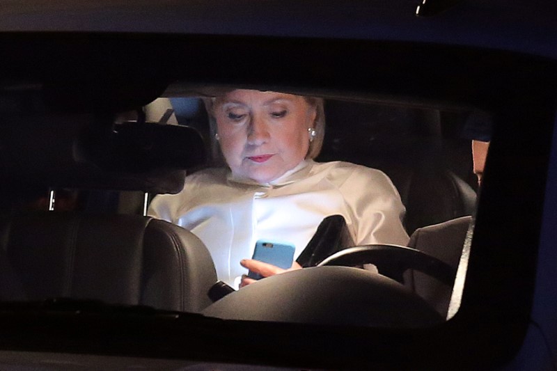 © Reuters. Democratic nominee Hillary Clinton looks at her mobile phone as she leaves her house to attend Congressional Black Caucus Foundation's Phoenix Awards Dinner at the Washington convention center in Washington