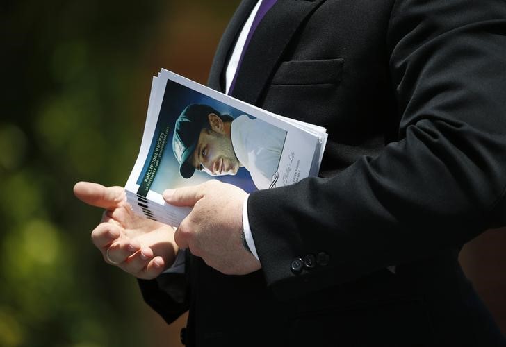 © Reuters. An order of service for the funeral of Australian cricketer Phillip Hughes is pictured prior to being distributed to mourners in his home town of Macksville