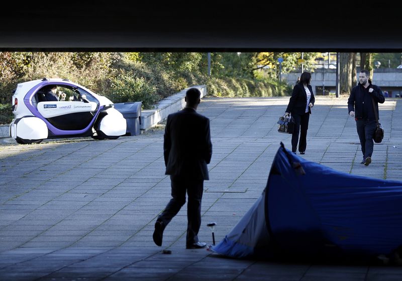 © Reuters. A driverless pod approaches a homeless person's tent as it is tested in Milton Keynes