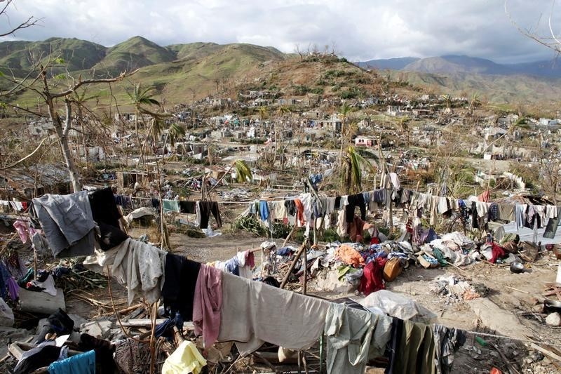 © Reuters. Clothes hang in an area destroyed by Hurricane Matthew in Les Anglais, Haiti