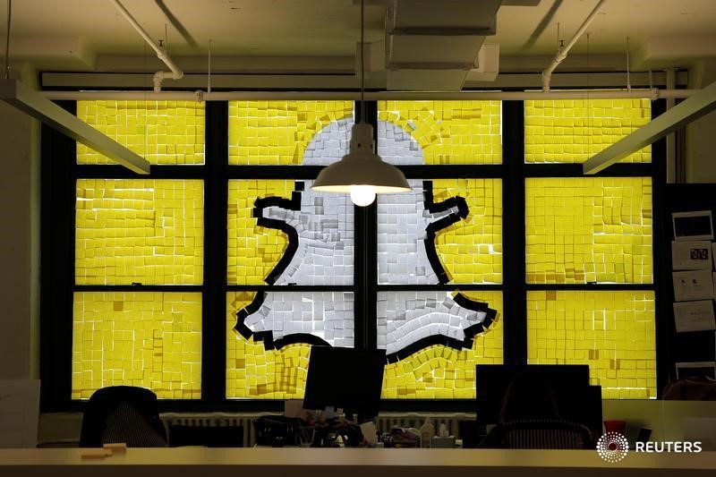 © Reuters. Snapchat logo image created with Post-it notes is seen in the windows of Havas Worldwide offices at 200 Hudson street in lower Manhattan, New York during "Post-it note war"