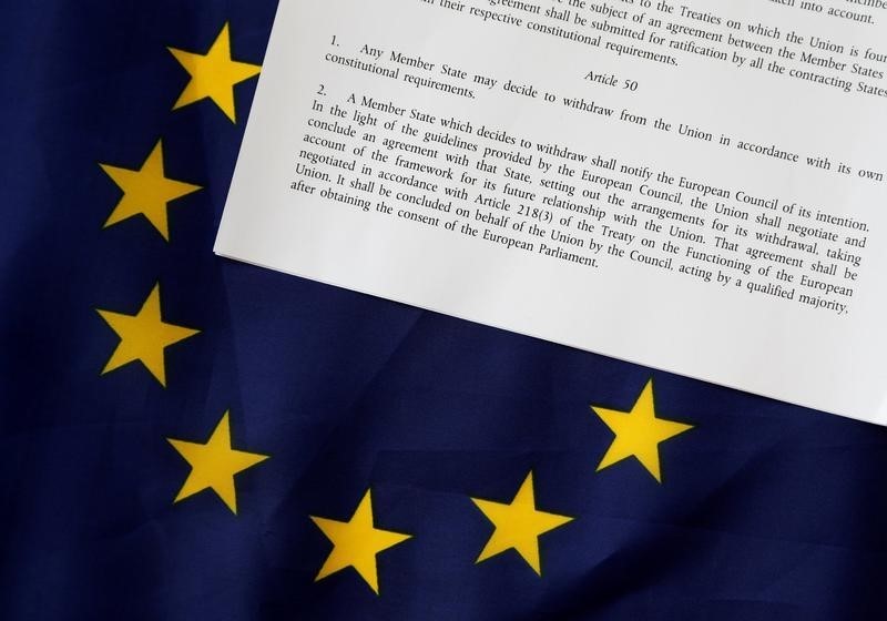 © Reuters. Article 50 of the EU's Lisbon Treaty is pictured with an EU flag following Britain's referendum results to leave the European Union in this photo illustration