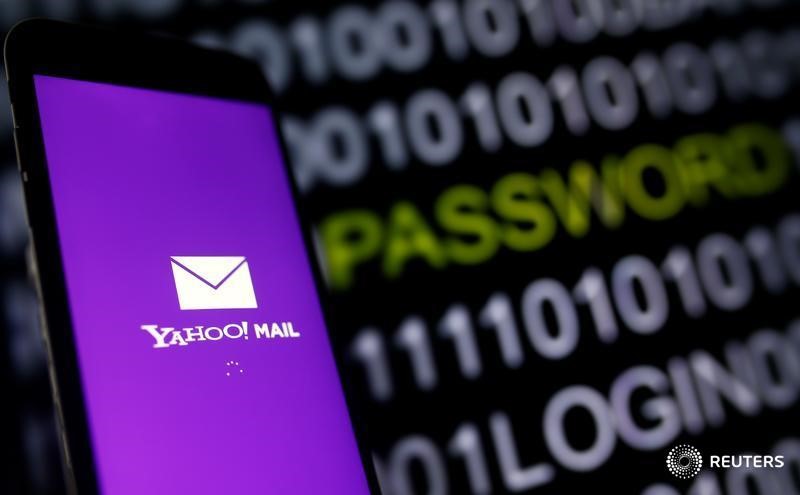 © Reuters. Yahoo Mail logo is displayed on a smartphone's screen in front of a code in this illustration