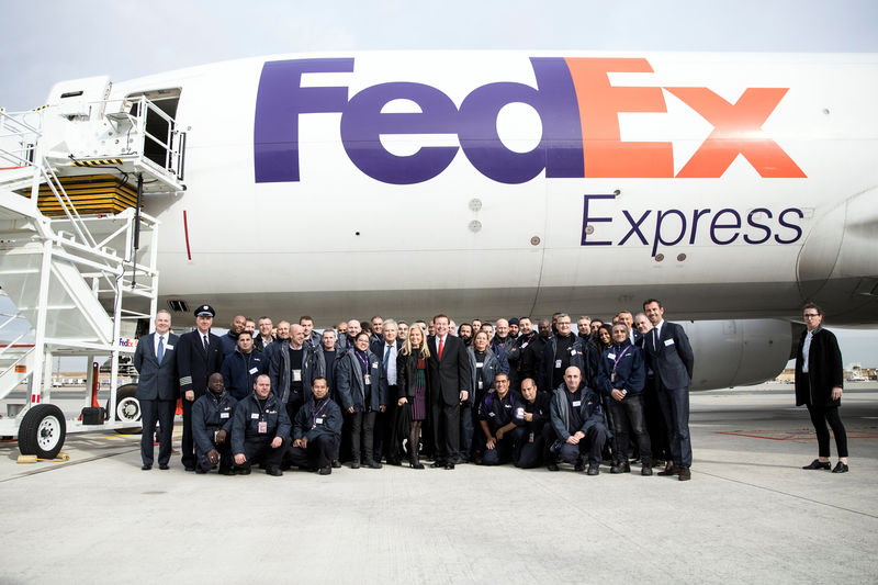 © Reuters. CEO and President of Fedex Express David Bronczek and US ambassador to France Jane Hartley pose with French FedEx workers following the presentation of the future extension of the FedEx hub in Roissy-en-France
