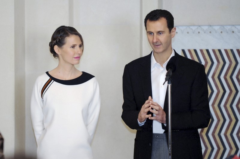 © Reuters. Presidente sírio, Bashar al-Assad, ao lado de esposa, Asma, durante cerimônia em Damasco