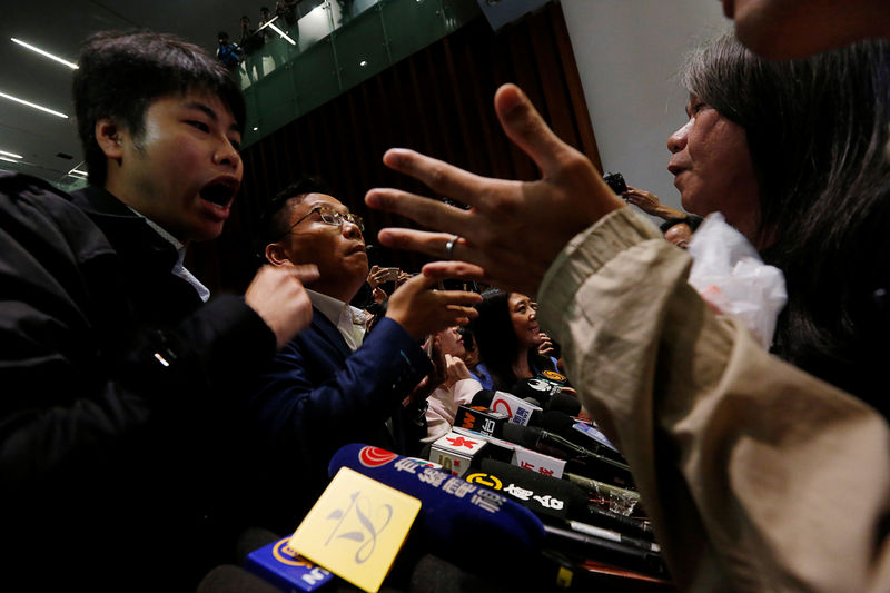 © Reuters. Pro-democracy lawmakers (R) argue with pro-Beijing lawmakers (L) after the latter staged a walk-out to stall activists Baggio Leung and Yau Wai-ching from swearing in at the Legislative Council in Hong Kong