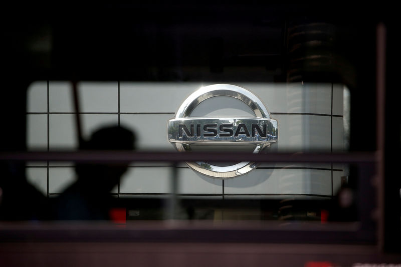 © Reuters. The logo of Nissan is seen through a window of a bus passing by its dealership in Seoul