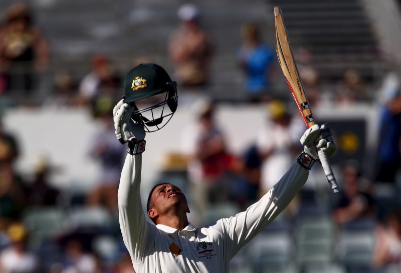 © Reuters. Australia's Usman Khawaja celebrates after reaching his century during the first day of the second cricket test match against New Zealand at the WACA ground in Perth, Western Australia