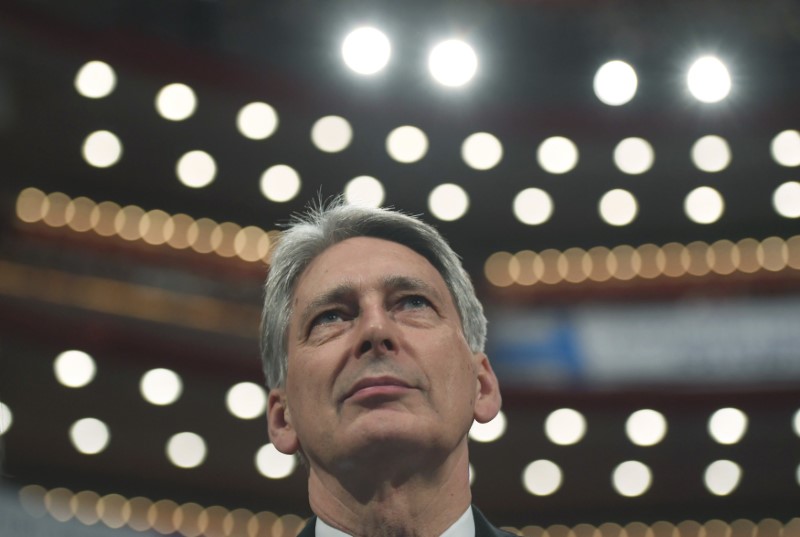 © Reuters. Britain's Chancellor of Exchequer Philip Hammond watches Prime Minister Theresa May speak at the annual Conservative Party Conference in Birmingham