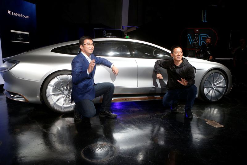 © Reuters. LeEco CEO and founder YT Jia, R, and co-founder and Global Vice Chairman Lei Ding pose in front of a LeSEE car during a press event in San Francisco