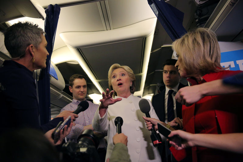 © Reuters. Democratic U.S. presidential candidate Hillary Clinton talks to the media inside of her campaign plane after the third and final 2016 presidential campaign debate in North Las Vegas
