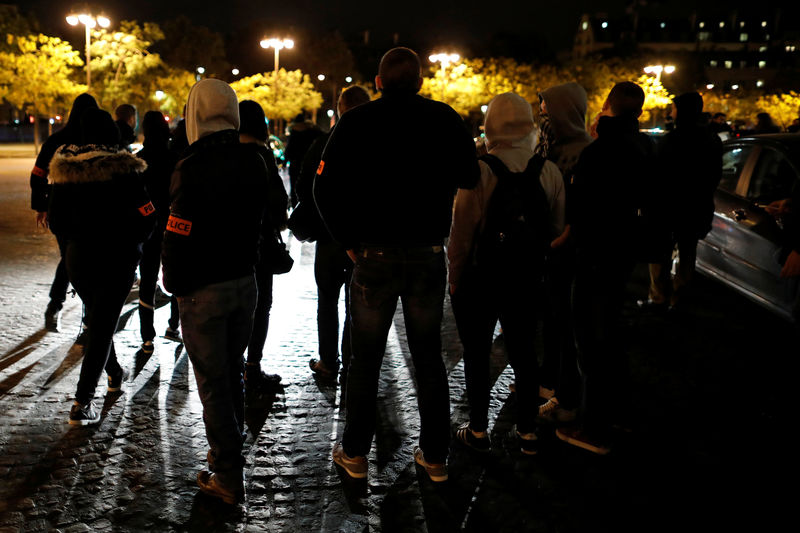 © Reuters. French plainclothes policemen gather during an unauthorised protest against anti-police violence on the Champs Elysees in Paris