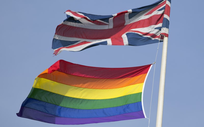 © Reuters. A rainbow flag flies with the Union flag above British Cabinet Offices, marking the first day Britain has allowed same sex marriages, in London