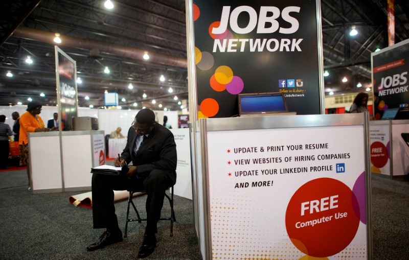 © Reuters. File photo of a job-seeker completing an application at a career fair in Philadelphia