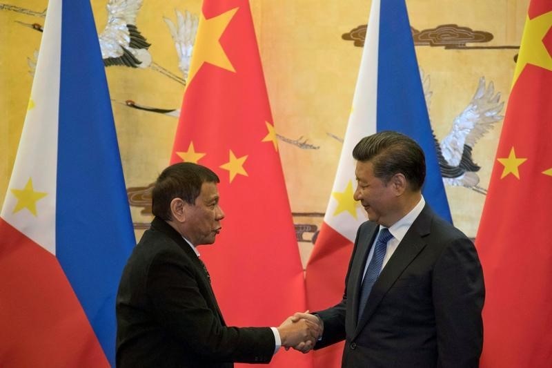 © Reuters. Philippine President Rodrigo Duterte and Chinese President Xi Jinping shake hands after a signing ceremony held in Beijing