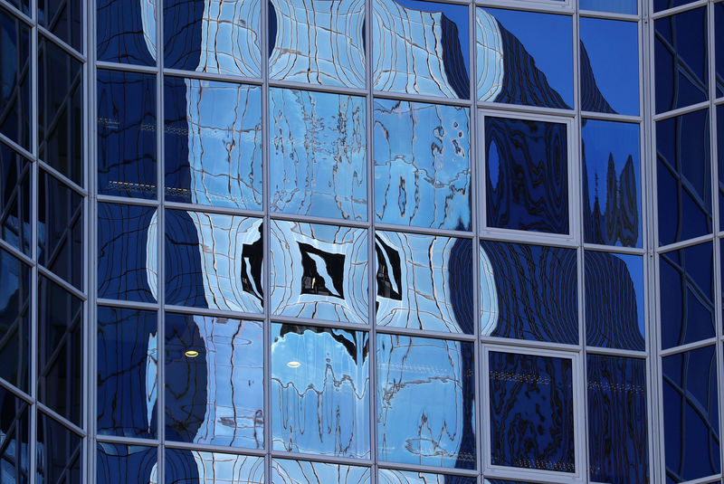 © Reuters. The logo of Germany's Deutsche Bank is reflected in the windows of a skyscraper in Frankfurt