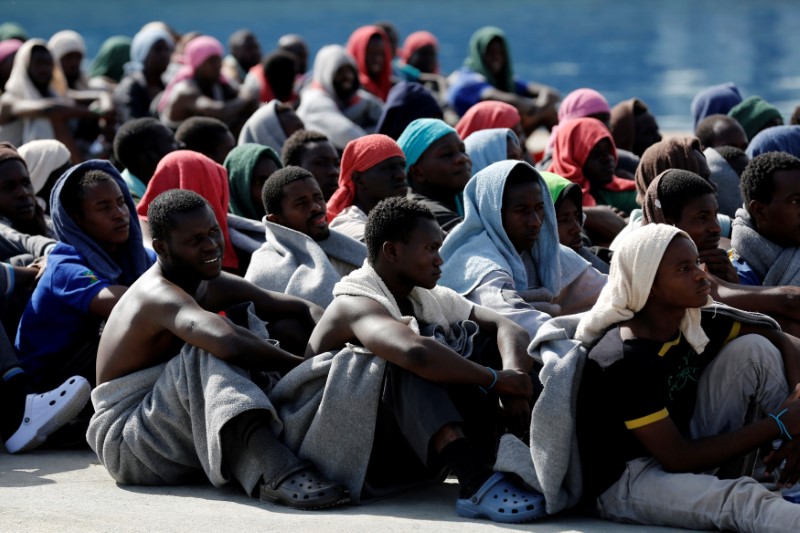 © Reuters. Migrants rests after disembarking from Dignity ship in the Sicilian harbour of Augusta