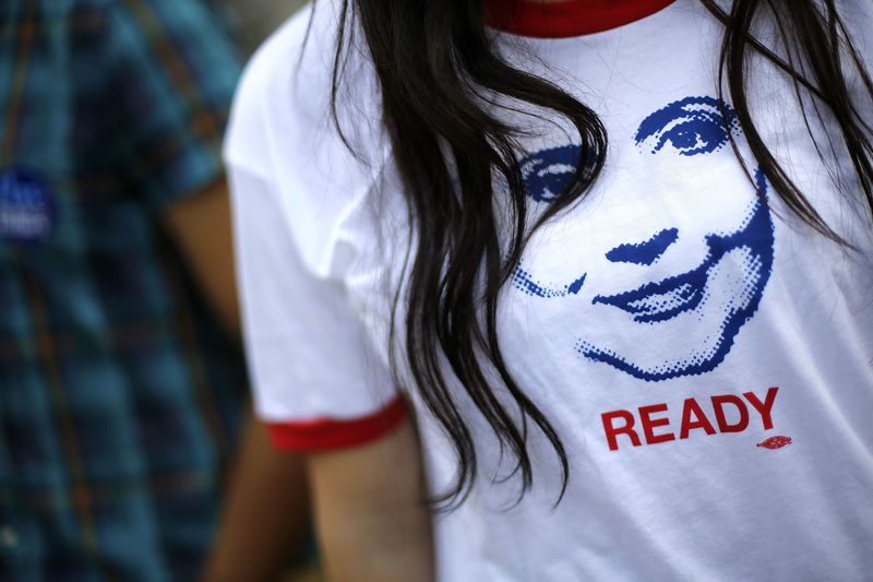 © Reuters. File photo of a supporter of former U.S. Secretary of State Hillary Clinton wearing a T-shirt with an image depicting her as people arrive to hear her speak about her new book "Hard Choices" in Washington