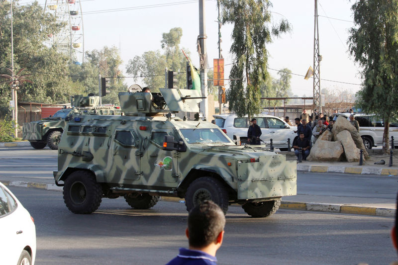 © Reuters. Military vehicles of peshmerga forces are seen at a site of an attack by Islamic State militants in Kirkuk