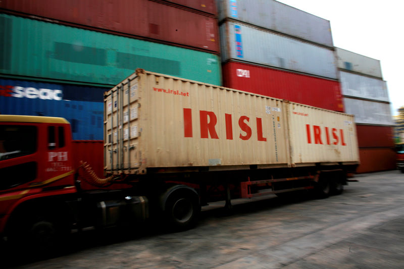 © Reuters. FILE PHOTO: A truck carrying IRISL containers arrives a depot in northern Singapore
