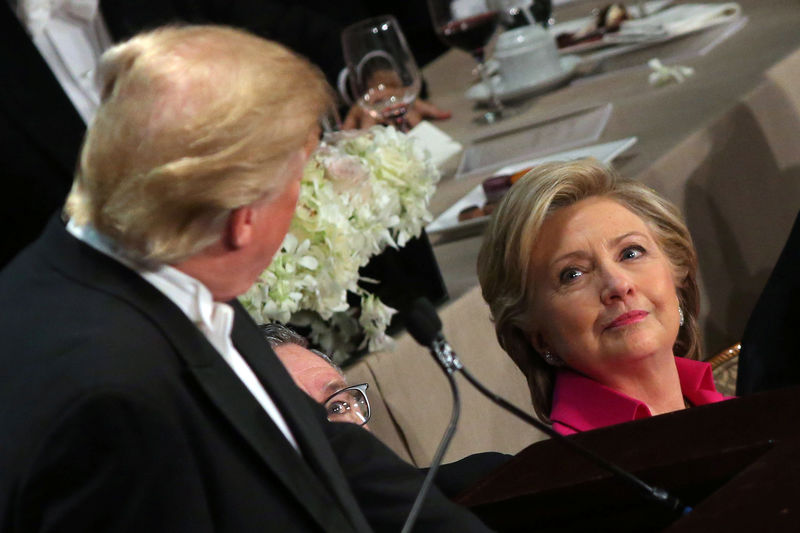 © Reuters. Democratic U.S. presidential nominee Hillary Clinton looks at Republican U.S. presidential nominee Donald Trump as he speaks during the Alfred E. Smith Memorial Foundation dinner in New York, U.S.