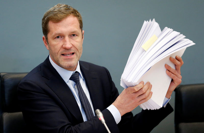 © Reuters. Minister-President of Wallonia Magnette holds up notes during a debate on CETA at the Walloon regional parliament in Namur