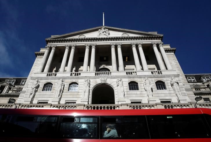 © Reuters. People travel on a bus as it passes the Bank of England in the City of London
