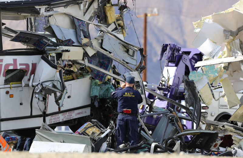 © Reuters. An investigator documents the scene of a mass casualty bus crash on the westbound Interstate 10 freeway near Palm Springs, California