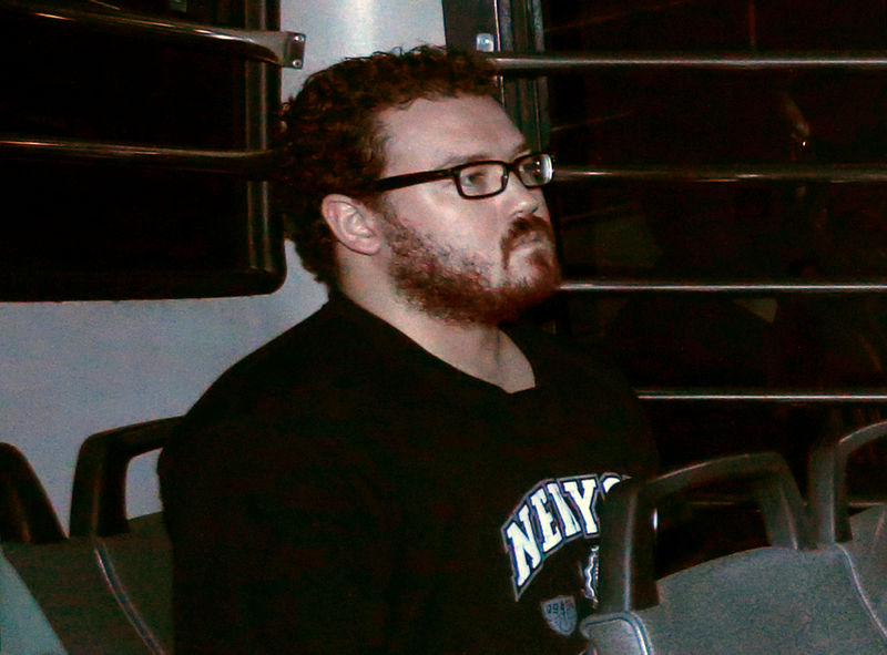 © Reuters. File photo of Jutting, a British banker charged with two counts of murder, sitting in the back row of a prison bus as he arrives at the Eastern Law Courts in Hong Kong
