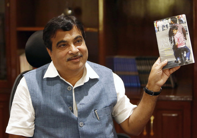 © Reuters. India's Transport and Shipping Minister Gadkari displays a book written by him at his office in New Delhi