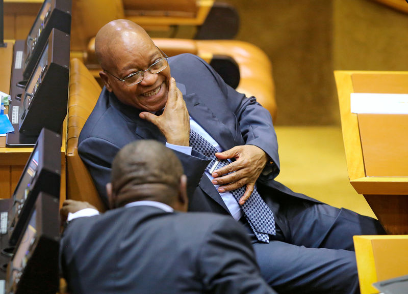 © Reuters. South African President Zuma laughs ahead of Finance Minister Gordhan's medium term budget speech in Cape Town