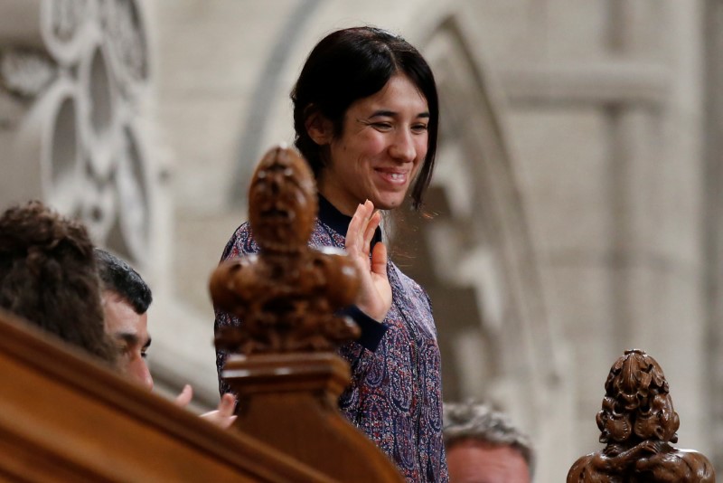 © Reuters. Nadia Murad Basee Taha, U.N. Goodwill Ambassador for the Dignity of Survivors of Human Trafficking, waves while being recognized in the House of Commons in Ottawa
