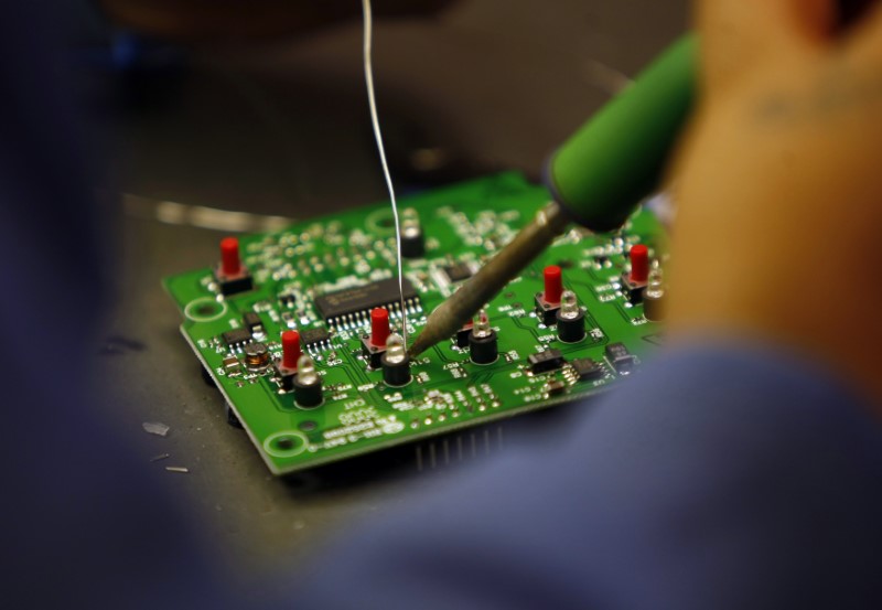© Reuters. A worker solders a circuit board at the manufacturing facility of VAS, an Electronics manufacturer  in San Diego