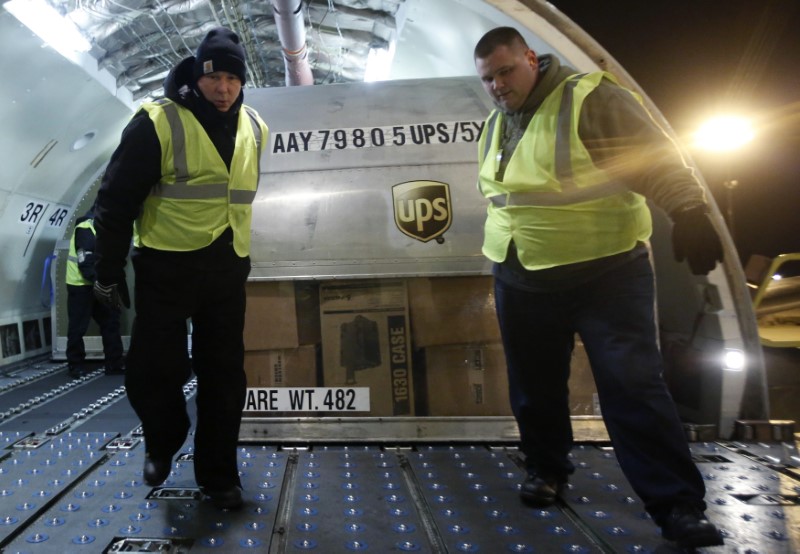 © Reuters. United Parcel Service (UPS) employees unload packages from the cargo of an airplane at the Regional Air Hub in Rockford