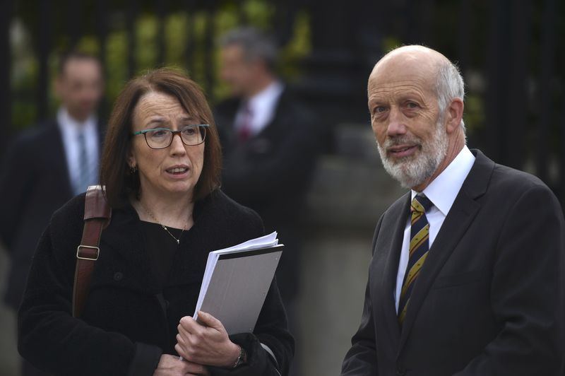 © Reuters. Solicitor Fiona Cassidy and David Forde of the Alliance party depart the High Court in Belfast