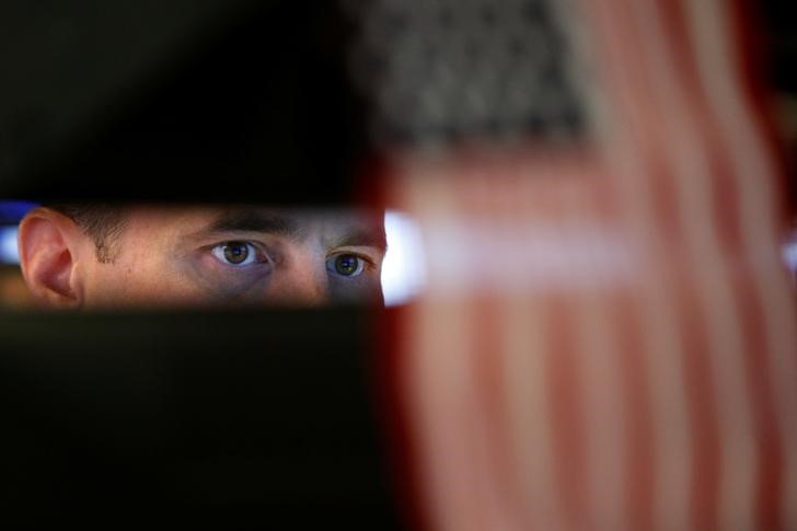 © Reuters. A specialist trader works at his post on the floor of the NYSE