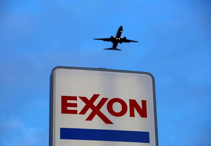 © Reuters. An airplane comes in for a landing above an Exxon sign at a gas station in the Chicago suburb of Norridge