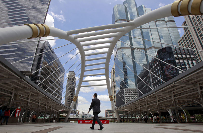© Reuters. FILE PHOTO: A man walks in business area in Bangkok