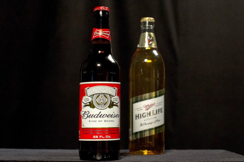 © Reuters. A bottle of Budweiser and a bottle of Miller High Life are pictured together in this photo illustration in the Manhattan borough of New York