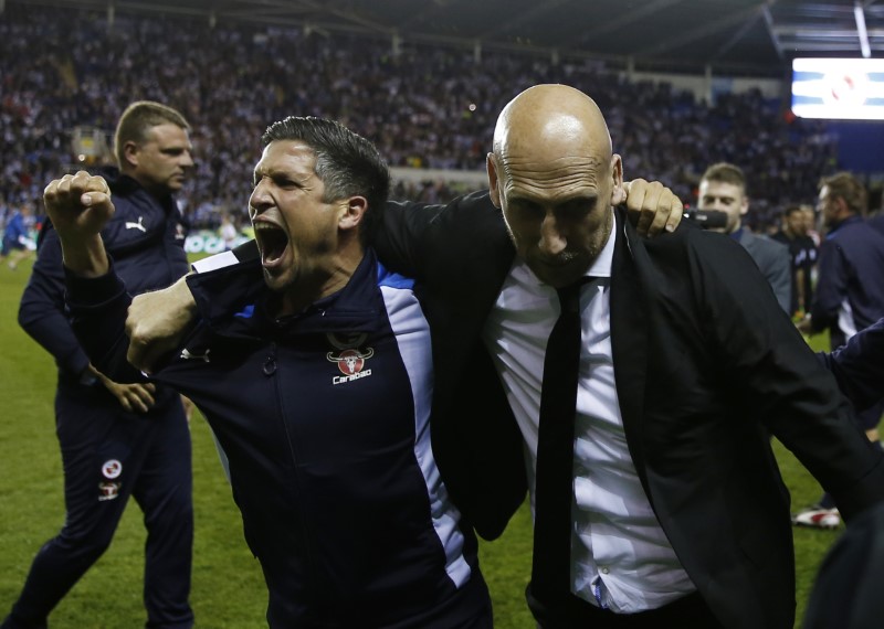 © Reuters. Reading manager Jaap Stam (R) celebrates at the end of the match after reaching the Play Off final