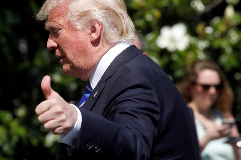 © Reuters. President Donald Trump gestures as he walks on the South Lawn