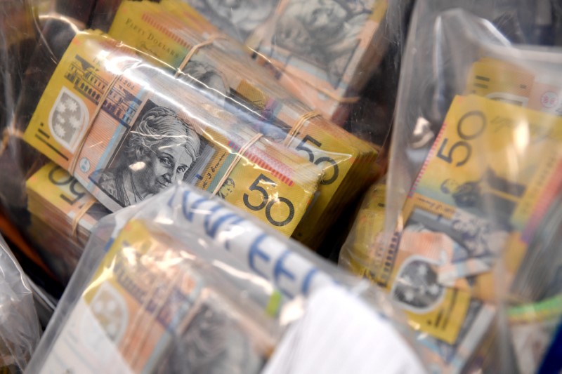 © Reuters. Seized items from a tax fraud investigation are displayed at a news conference at the Australian Federal Police headquarters in Sydney