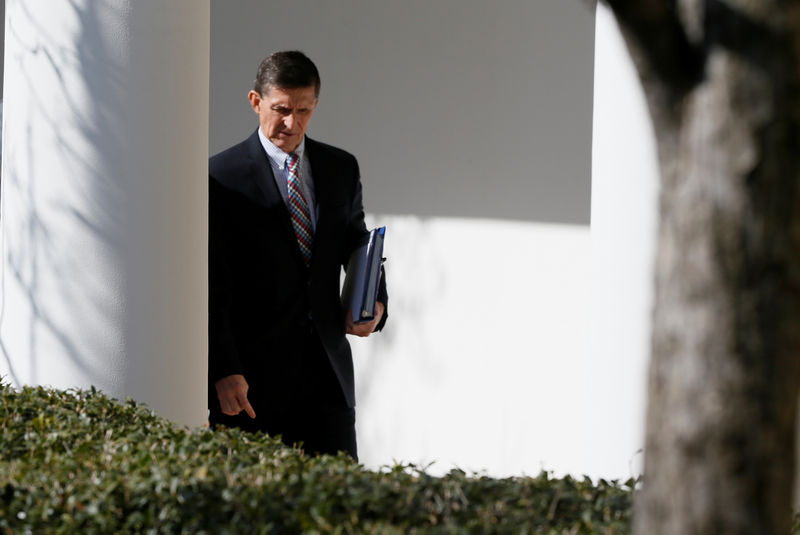 © Reuters. White House National Security Advisor Flynn walks down the White House colonnade on the way to Abe and Trump joint news conference at the White House in Washington